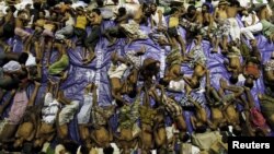 Migrants believed to be Rohingya rest inside a shelter after being rescued from boats at Lhoksukon in Indonesia's Aceh province, May 11, 2015. 