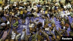 FILE - Migrants believed to be Rohingya rest inside a shelter after being rescued from boats at Lhoksukon in Indonesia's Aceh province, May 11, 2015. 