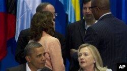 President Barack Obama, left, and Secretary of State Hillary Rodham Clinton attend the plenary session of the sixth Summit of the Americas in Cartagena, Colombia, Saturday April 14, 2012.