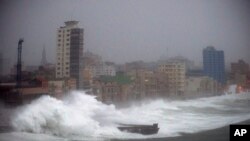 FILE - In this Sept. 9, 2017 file photo, strong waves brought by Hurricane Irma hit the Malecon seawall in Havana, Cuba. The elegant, seaside boulevard, where early 20th-century buildings are pounded with massive waves during storms and cold fronts, is now being pushed toward collapse by rising seas, more intense hurricanes, and decades of neglect. 