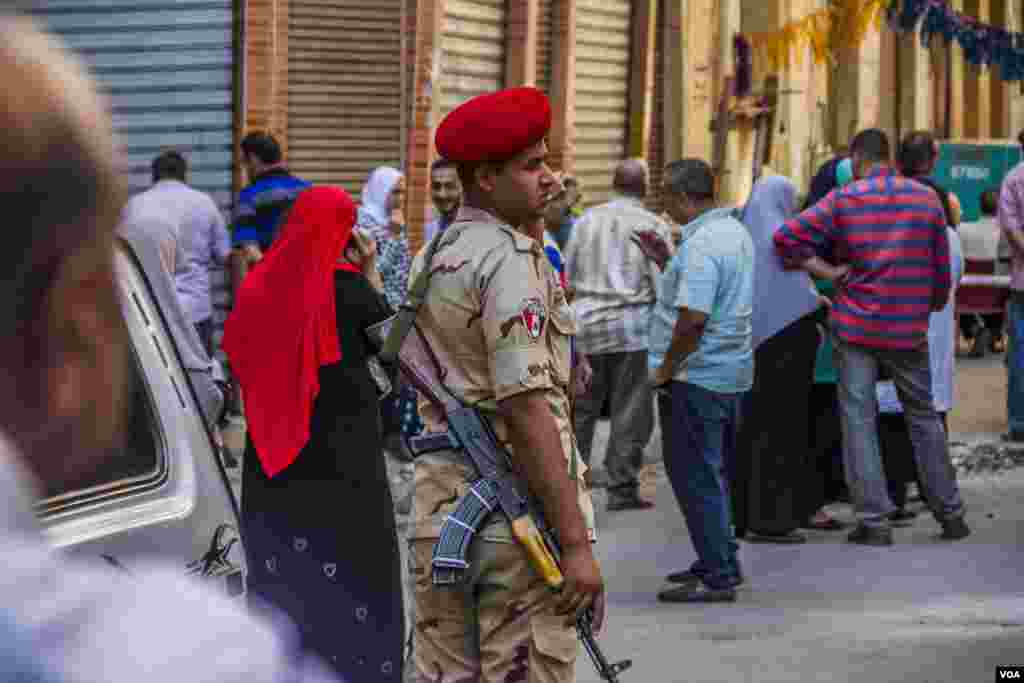 A soldier guards the demolition area, the Alexandria tramway network in this area has been blocked to prevent fluctuations that may cause buildings break apart. Sunday, June 4, 2017. (H. Elrasam/VOA)