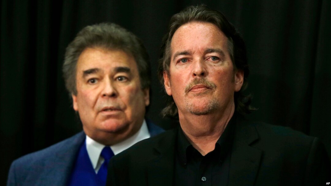 FILE- In this April 22, 2016, photo, Hillary Clinton's brothers Tony Rodham, right, and Hugh Rodham await her presidential campaign appearance in Dunmore, Pa. Tony Rodham died June 7, 2019, Clinton announced on June 8. 
