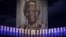 Candles are lit under a portrait of former South African President Nelson Mandela in his ancestral village of Qunu, Dec. 15, 2013.