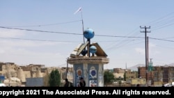 A Taliban flag flies in the square of Ghazni city after fighting between Taliban and Afghan security forces in Ghazni, southwest of Kabul, Afghanistan, Thursday, Aug. 12, 2021. The Taliban captured the provincial capital near Kabul on Thursday, the…