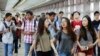 FILE - Students arrive for the first day of school at Stuyvesant High School in New York, Sept. 9, 2015. 