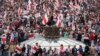 Opposition supporters with old Belarusian national flags rally at Independence Square in Minsk.