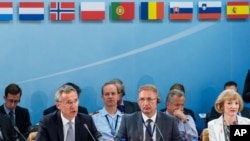 NATO Secretary General Jens Stoltenberg, left, talks during a North Atlantic Council Meeting at NATO headquarters in Brussels on Tuesday July 28, 2015.