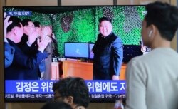 FILE - In this May 5, 2019, photo, people watch a TV showing a photo of North Korean leader Kim Jong Un during a news program reporting a North Korean missile launch, at the Seoul Railway Station in Seoul, South Korea.