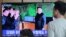 FILE - People watch a TV showing a photo of North Korean leader Kim Jong Un during a news program reporting a North Korean missile launch, May 5, 2019, at the Seoul Railway Station in Seoul, South Korea. 