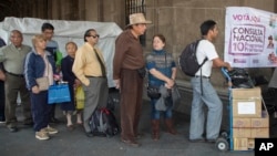 Voters stand in line in Mexico City, Saturday, Nov. 24, 2018, to cast their decision on the referendum regarding the construction of the so called "Mayan Train", that would connect several cities of the Yucatan peninsula.