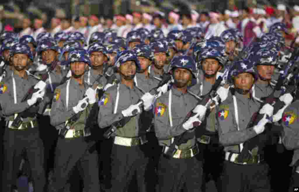 Myanmar police officers march during a ceremony to mark Myanmar's 67th anniversary of Independence Day in Naypyitaw, Myanmar, Sunday, Jan. 4, 2015. (AP Photo/Gemunu Amarasinghe)