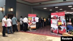 Job seekers line up at a job fair of an oil services giant Halliburton at the MCM Grande Fundome hotel in Odessa, Texas, July 19, 2018.