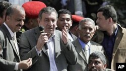 Egyptian PM-designate Essam Sharaf, with microphone, speaks to demonstrators in Tahrir Square in Cairo, March 4 2011