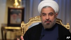  Iranian President Hassan Rouhani speaks during an interview with state television at the presidency in Tehran, Sept. 10, 2013.