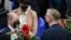Designated German Chancellor Olaf Scholz (L) is offered flowers by Parliamentary group co-leader "Die Linke" after being elected as Germany's new Chancellor in Berlin on Dec. 8, 2021.