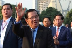 FILE - Cambodian Prime Minister Hun Sen waves to government civil servants in Phnom Penh, Cambodia, Jan. 7, 2020.