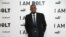 Sprinter Usain Bolt, who has won nine Olympic gold medals,  poses for photographers upon arrival at the World premiere of the film 'I Am Bolt' in London, Nov. 28, 2016.