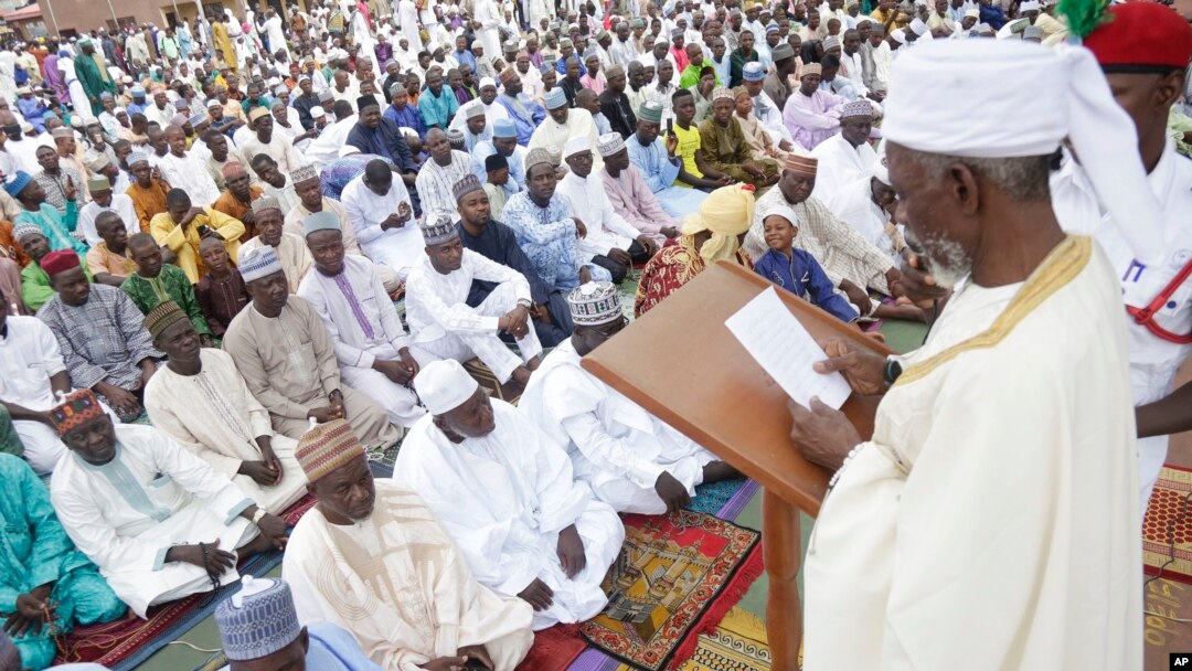 FILE - Nigeria Muslims listen to the sermon by Imam Bashir Umar, during Eid al-Fitr prayers in Lagos, Nigeria, to mark the end of the month of Ramadan, June 25, 2017.