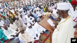 FILE - Nigeria Muslims listen to the sermon by Imam Bashir Umar, during Eid al-Fitr prayers in Lagos, Nigeria, to mark the end of the month of Ramadan, June 25, 2017.