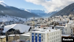FILE - Snow covers rooftops, on the first day of the annual meeting of the World Economic Forum in Davos, Switzerland, January 15, 2024