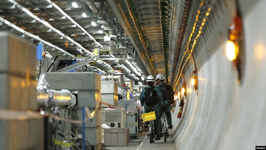 Technicians ride bikes in the tunnel of the Large Hadron Collider (LHC) experiment during a media visit at the European Organization for Nuclear Research (CERN) in Meyrin near Geneva, Switzerland on February 16, 2016. 