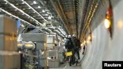 Technicians ride bikes in the tunnel of the Large Hadron Collider (LHC) experiment during a media visit at the European Organization for Nuclear Research (CERN) in Meyrin near Geneva, Switzerland on February 16, 2016. 