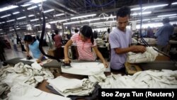 FILE - Workers iron and arrange clothing at a garment factory at Hlaing Taryar industrial zone in Yangon, March 10, 2010. (REUTERS/Soe Zeya Tun/File Photo)