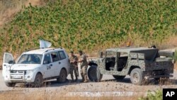 FILE - Lebanese soldiers with U.N officials patrol in the southern Lebanese village of Aitaroun along the Israel-Lebanon border, Israel, Aug. 27, 2019. 