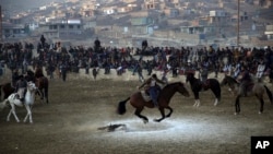 Afghan horse riders compete for the goat during a friendly buzkashi match on the outskirts of Kabul, Afghanistan.