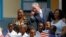 Former US President George W. Bush greets children at a school in Gaborone, Botswana, April 4, 2017.