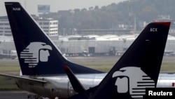 FILE - Aeromexico aeroplanes are seen on the airstrip at Benito Juarez international airport in Mexico City, July 8, 2015.