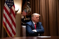 President Donald Trump listens during a meeting with Hispanic leaders in the Cabinet Room of the White House, July 9, 2020, in Washington.