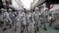 Army soldiers wearing protective suits spray disinfectant as a precaution against the new coronavirus at a shopping street in Seoul, South Korea, March 4, 2020. 
