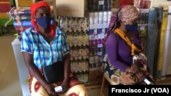 Deux femmes déplacées attendent à l'intérieur d'un magasin à Pemba avec lequel le PAM a conclu un accord afin que les personnes fuyant la violence à Cabo Delgado puissent obtenir de la nourriture et d'autres produits au Mozambique le 5 avril 2021