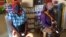 Deux femmes déplacées attendent à l'intérieur d'un magasin à Pemba avec lequel le PAM a conclu un accord afin que les personnes fuyant la violence à Cabo Delgado puissent obtenir de la nourriture et d'autres produits au Mozambique le 5 avril 2021