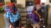 Duas mulheres deslocadas esperam pelos seus produtos dentro de uma loja contratada pelo PMA para fornecer produtos aos que fogem da violência armada no norte de Cabo Delgado. Moçambique