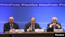 FILE - Foreign Ministers, Sergei Lavrov, center, of Russia, Mevlut Cavusoglu, left, of Turkey and Mohammad Javad Zarif of Iran attend the international meeting on Syria in Astana, Kazakhstan, March 16, 2018. 