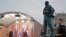 Cuba's President Miguel Diaz-Canel Bermudez, left, and Russian President Vladimir Putin take part in the unveiling ceremony of a monument to the late Cuban leader Fidel Castro, right, in Moscow, Russia, Nov. 22, 2022. 