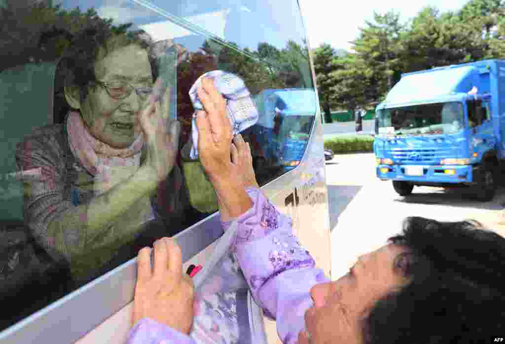 South Koreans (on the bus) bid farewell through the window to their North Korean relatives at the end of a three-day family reunion event at North Korea&#39;s Mount Kumgang resort. Elderly North and South Korean family members were allowed to meet for the first time in nearly seven decades.