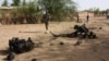 Des soldats nigériens marchent près des débris après des attaques kamikazes à Agadez, Niger (photo d'archives)