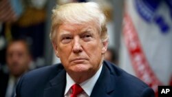 President Donald Trump listens during a meeting of the President's National Council of the American Worker in the Roosevelt Room of the White House, Sept. 17, 2018, in Washington. 