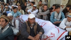 Shi'ite Muslims attend the funeral for victims of an ambush by gunmen on a car, in Quetta, Pakistan, Oct. 9, 2017. 