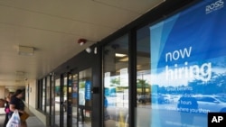 FILE - A hiring sign is displayed at a retail store in Schaumburg, Illinois, July 15, 2021.