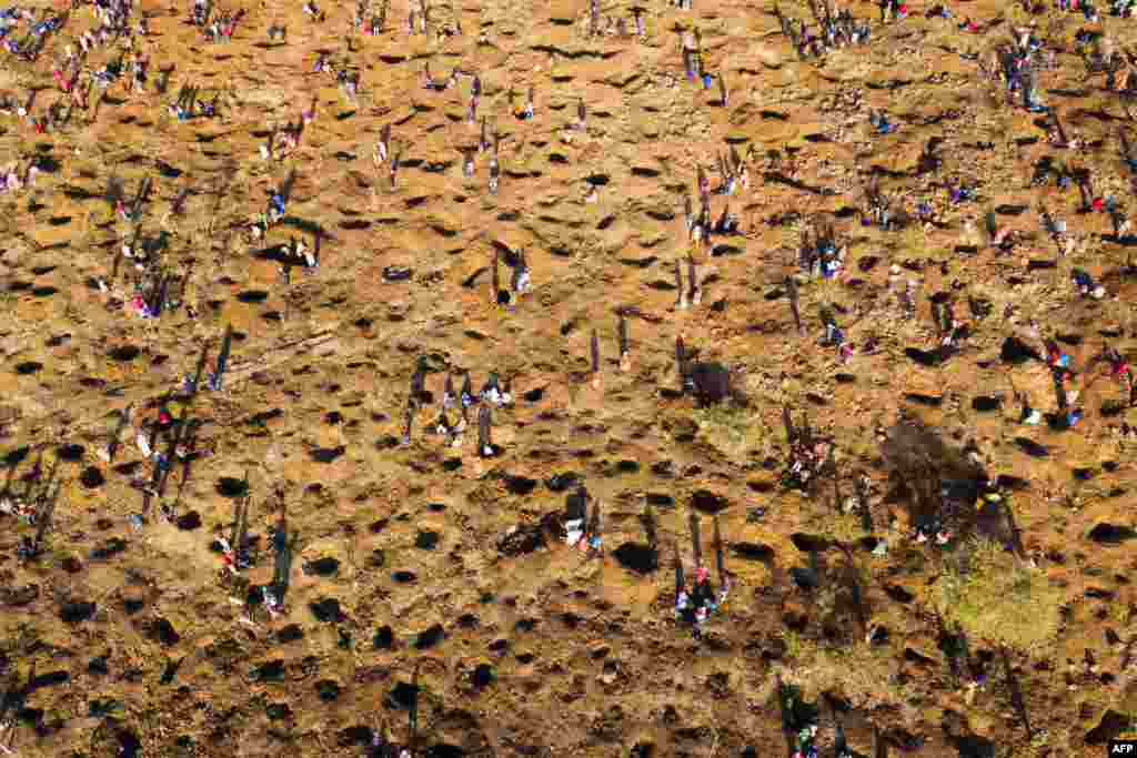 An aerial view shows people digging as they search for what they believe to be diamonds, after the discovery of unidentified stones at KwaHlathi village near Ladysmith in KwaZulu Natal, South Africa.