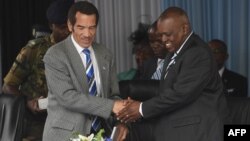 FILE - Botswana's President Seretse Ian Khama (L) shakes hands with his vice-president Mokgweetsi Masisi during a rally in his village Serowe on March 27, 2018, before officially stepping down on March 31 and handing power to his vice-president on April 1