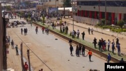 FILE - Anti-government demonstrators block a road in Bamenda, Cameroon, Dec. 8, 2016. 