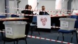 Kosovo electoral commission staff sit at a polling station in the town of Zvecan on April 21, 2024.