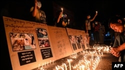 Protesters take part in a ceremony to pray for those who died during protests against the military coup in Yangon, Myanmar, Feb. 28, 2021.