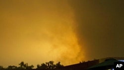 Sky over Tripoli, Libya, is illuminated by explosions during an airstrike, early Tuesday, May 24, 2011