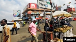 People walk on the street around Kwame Nkrumah circle in Accra, Ghana, Dec. 2, 2016. 